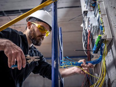 a-male-electrician-works-in-a-switchboard-with-an-2023-11-27-05-36-14-CJZ5K86.jpg a-male-electrician-works-in-a-switchboard-with-an-2023-11-27-05-36-14-CJZ5K86.jpg