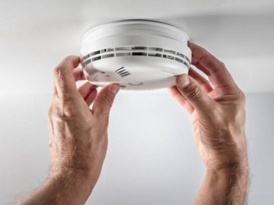 istockphoto-1707812169-612×612 Home smoke and fire alarm detector man installing, maintenance, checking, testing or replacing battery
